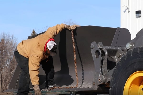 Truck-Driver-Securing-Front-End-Loader